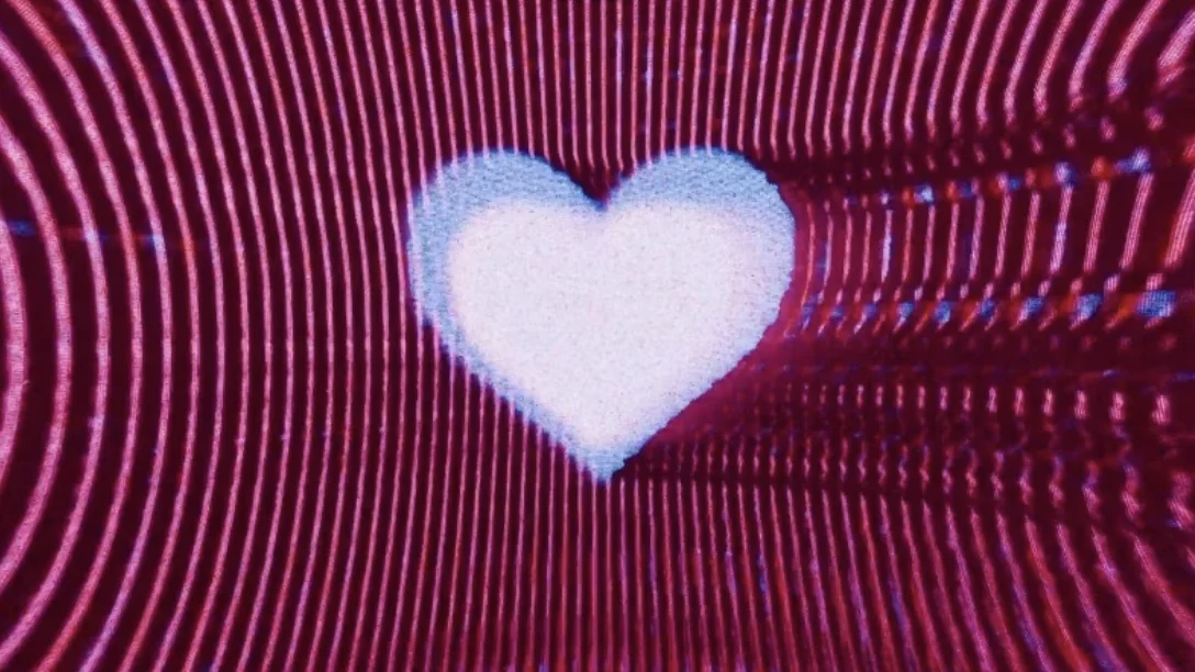 A glowing heart at the centre of radiating waves of red and violet light