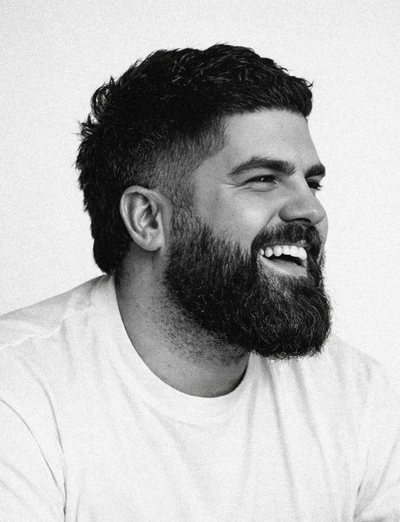 James Hazlett-Beard, certified neurocoach and founder of expansion works, laughing in black and white