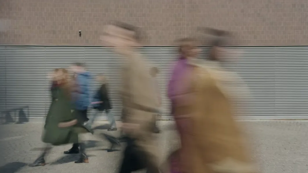 How to understand people you disagree with: strangers passing each other in motion blur on a city street