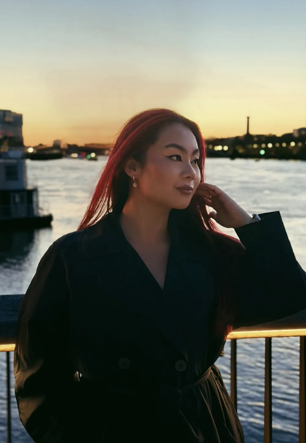 Mickey Jones at golden hour by the river, red hair catching the last of the light