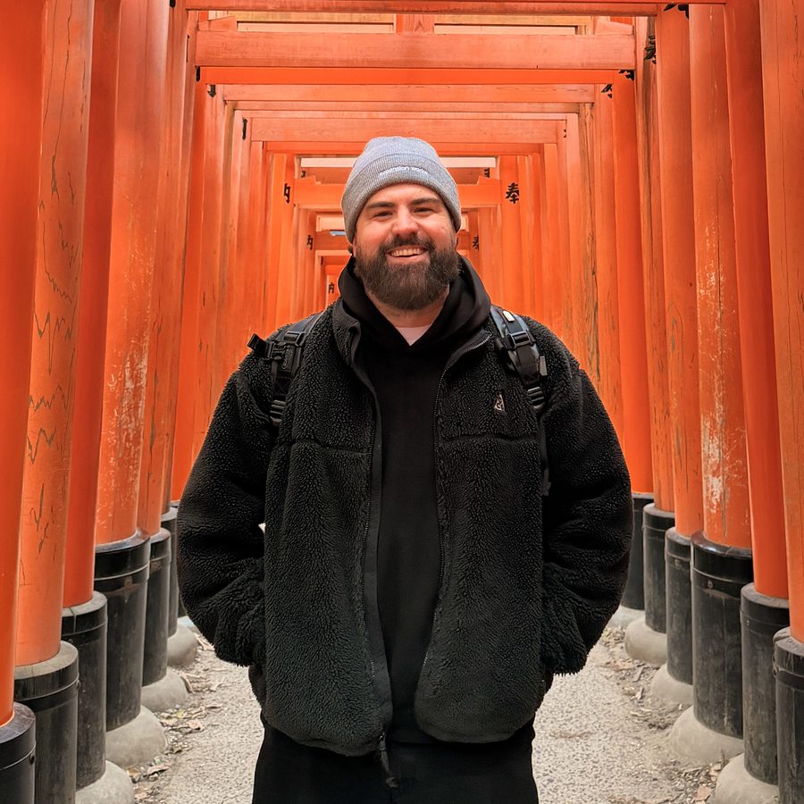 James under the orange torii gates at Fushimi Inari in Kyoto