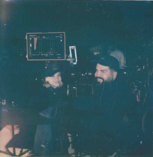 James behind a camera with the crew around him