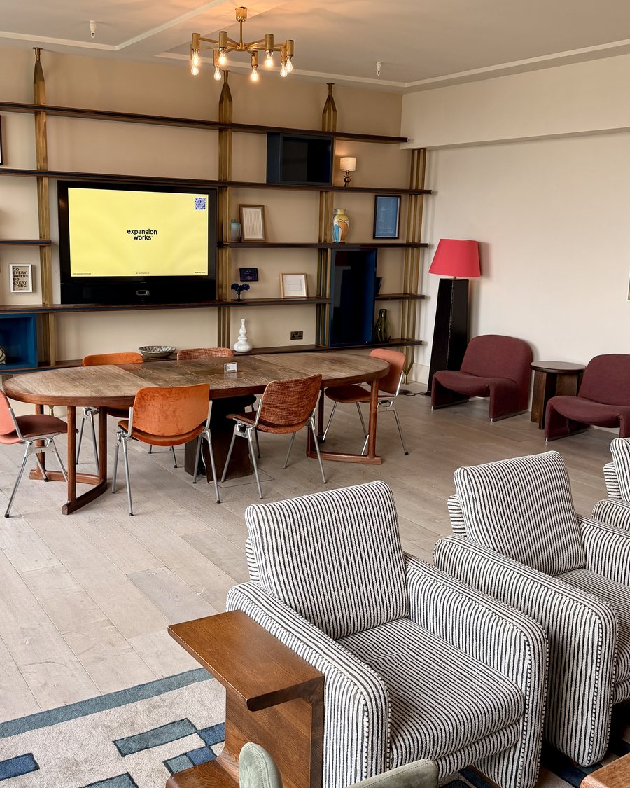 The room at Soho Works Shoreditch set up for a session, with expansion works on the screen